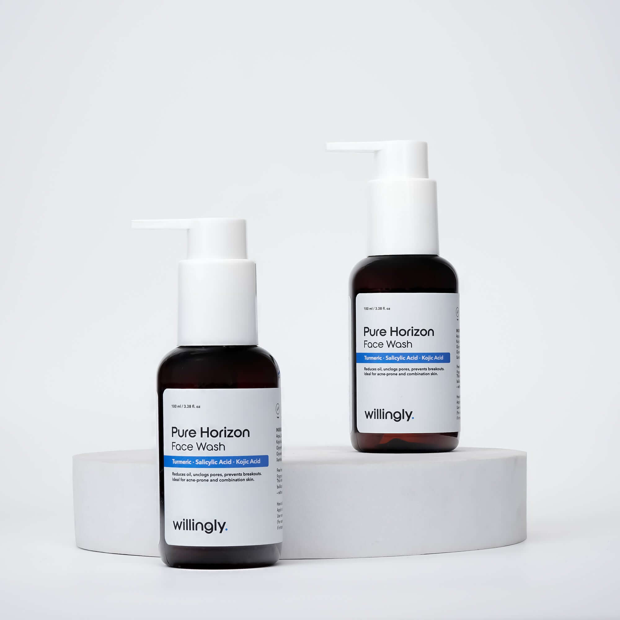 Two bottles of Willingly Pure Horizon Face Wash placed on white marble blocks for product display