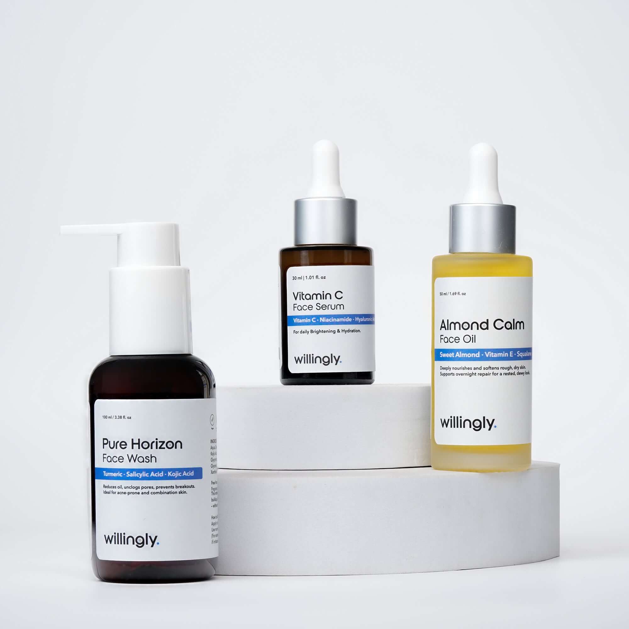 Willingly Glow Ritual Set with Pure Horizon Face Wash, Vitamin C Face Serum, and Almond Calm Face Oil on white marble display